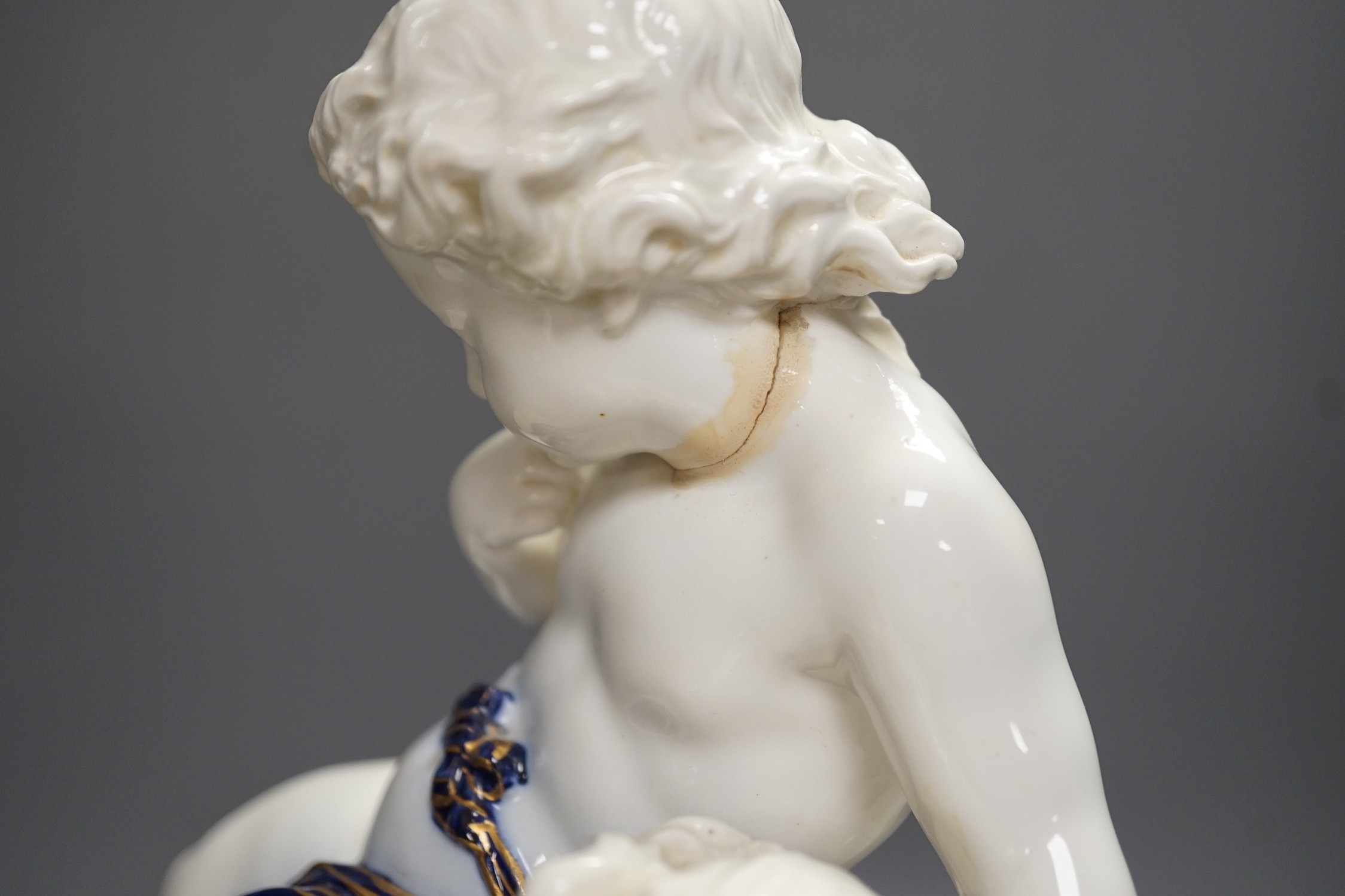 A Copeland porcelain putti seated on a shell centrepiece, modelled by O. Hale, c.1877, 35cms high